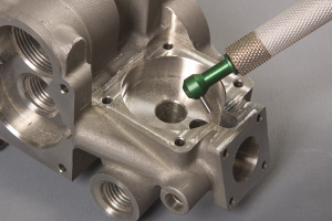 Deburr cross-drilled holes on industrial controls components with micro-precision sandblasting.