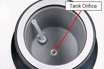 The tank orifice is located at the bottom of the abrasive tank on your Comco blaster.