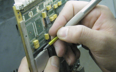 Conformal coating removal from circuit board using micro-precision sandblasting.