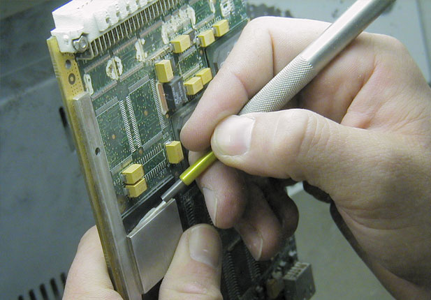 Conformal coating removal from circuit board using micro-precision sandblasting.