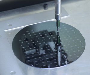 Processing semiconductor wafers by microblasting slots in the wafer