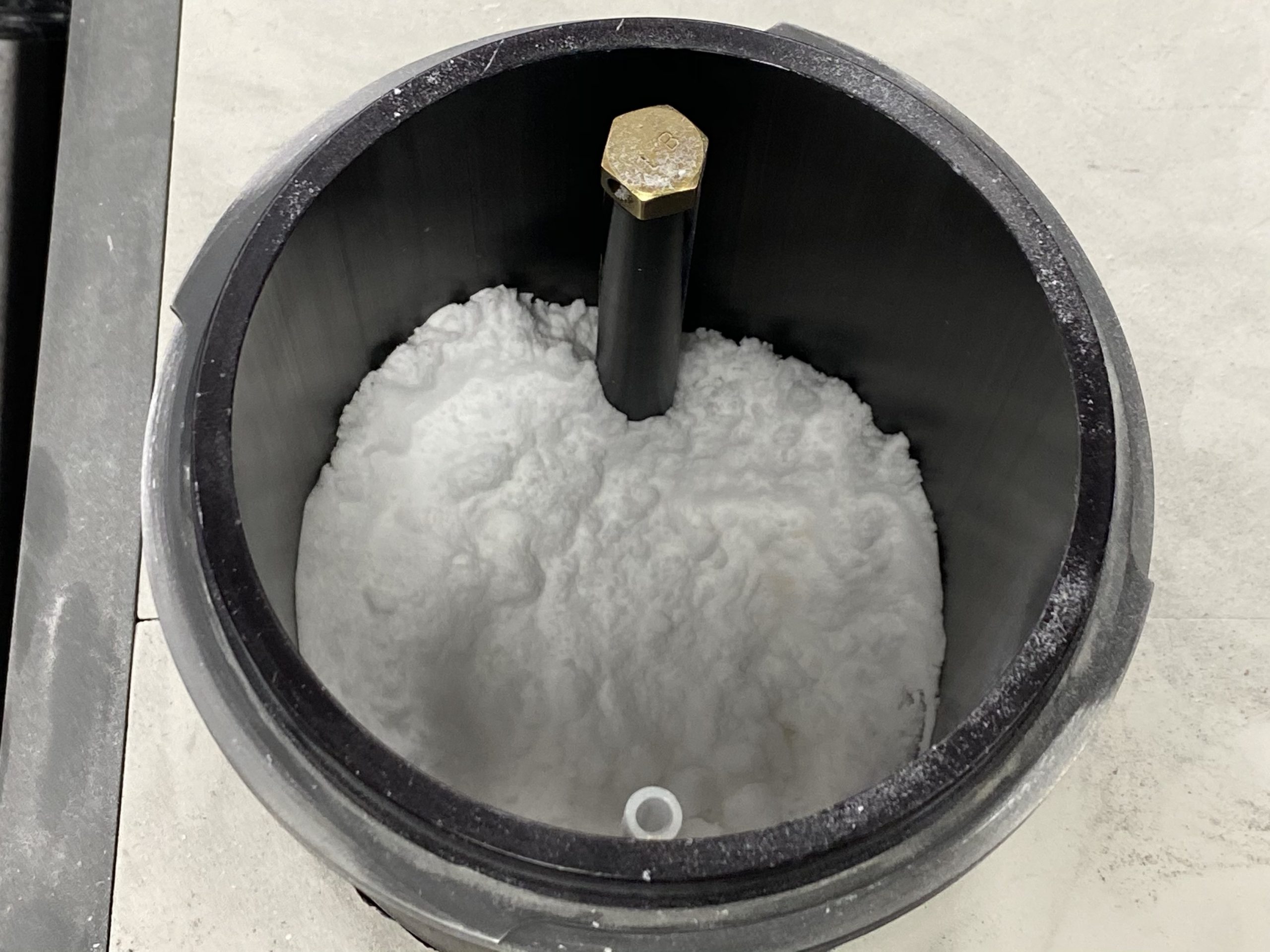 chunky sodium bicarbonate abrasive in an Accuflo Tank